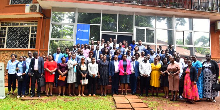 Catherine Poran Stanbic Business Incubator Chief Executive (C) poses for a group photo with SACCO beneficiaries and implementing partners; Courtesy Photo