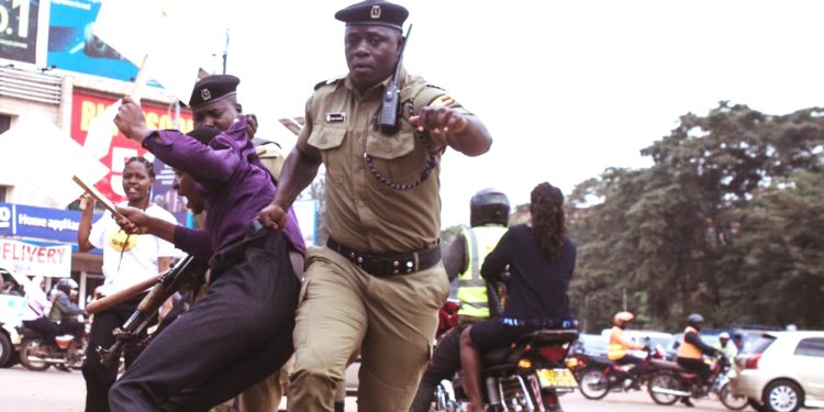 Police officer drags a protestor
