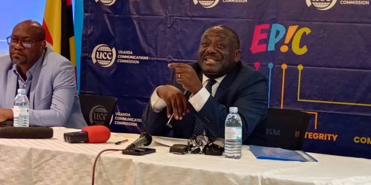 UCC Executive Director, Nyombi Thembo (R) while addressing journalists at UCC headquaters in Bugolobi: Courtesy Photo