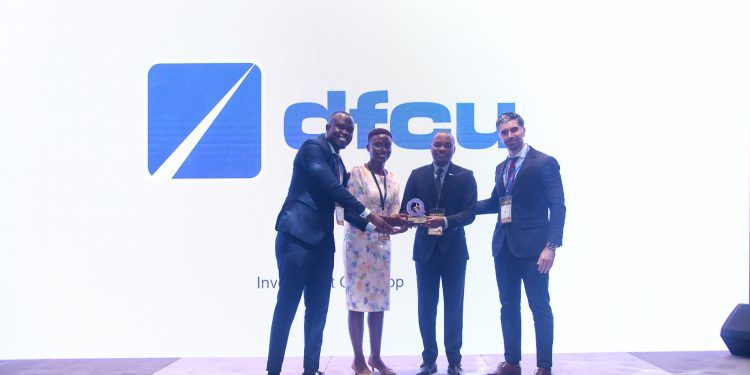 dfcu Bank Team led by Jude Kansiime, Head Customer Relations recieving the dfcu Investment App award in Dubai during the Qorus Awards