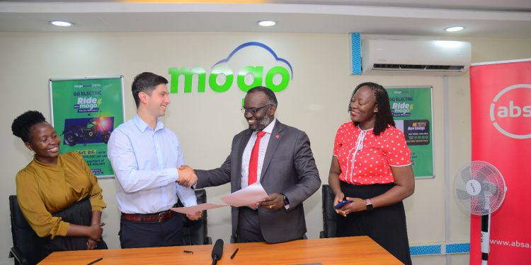 Absa Executive Director and Head of Financial Markets David Wandera ( in neckties) exchanges documents with Mogo CEO, Mikhail Vydryn