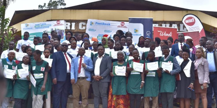 Martin Lukyamuzi (4th L) Regional Head of Distribution-Greater Kampala, PostBank Uganda, John Walugembe (6thL) FSME, Executive Director, official from PostBank Uganda and some of the Coffee Entrepreneurs who participated in the final Agri SME Skills Development Program 2024 Cohort, where entrepreneurs in Coffee were advise Coffee on value addition as a gateway to regional trade opportunities. The event was at UIRI in Nakawa today 23rd December 2024.