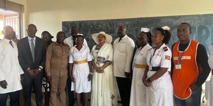 Speaker Anitah Among in a round hat with district health officers.