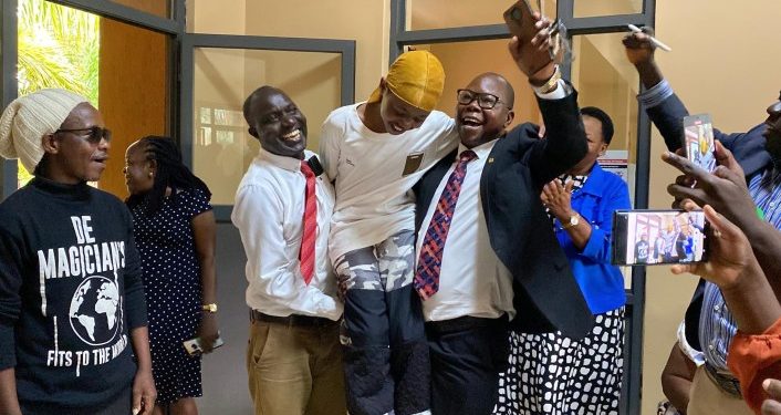 Fresh Kid carried by his teachers in jubilation.