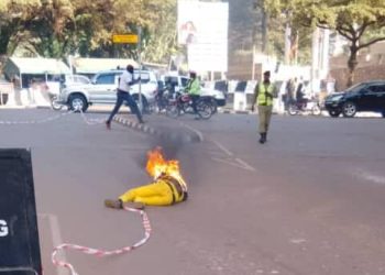 A man donning yellow attire sets fire on himself at the entrance of Parliament