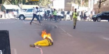 A man donning yellow attire sets fire on himself at the entrance of Parliament