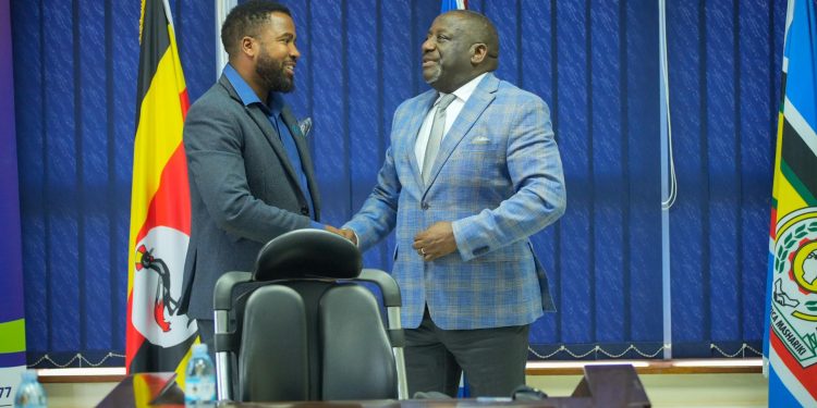 Left-Humphrey-Nabimanya-Founder-iKon-Awards-and-Right-UCC-Executive-Director-shake-hands