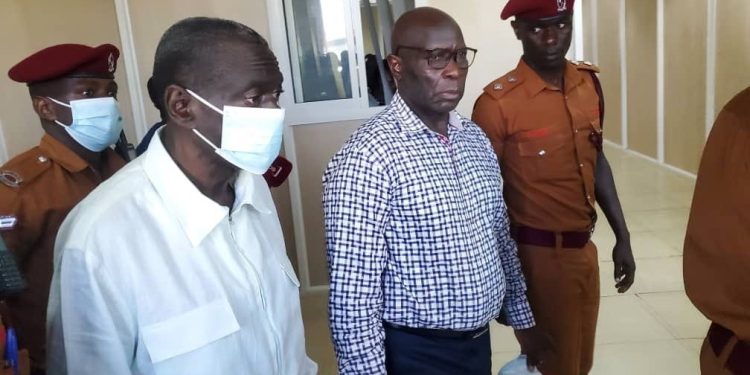 Col. Dr Kizza Besigye (in a mask) and Hajj Obedi Lutale. Courtesy Photo