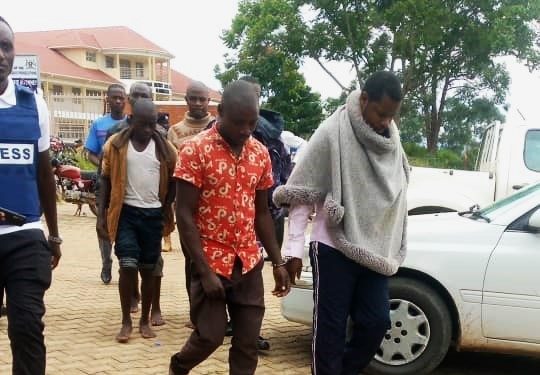 Levi Amarakutunga on the extreme left handcuffed with his co-accused arriving at Kamwenge Magistrate's Court.