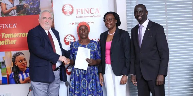 Janet Mudoola - the FINCA Brand Ambassador and FINCA Executives pose for a group photo