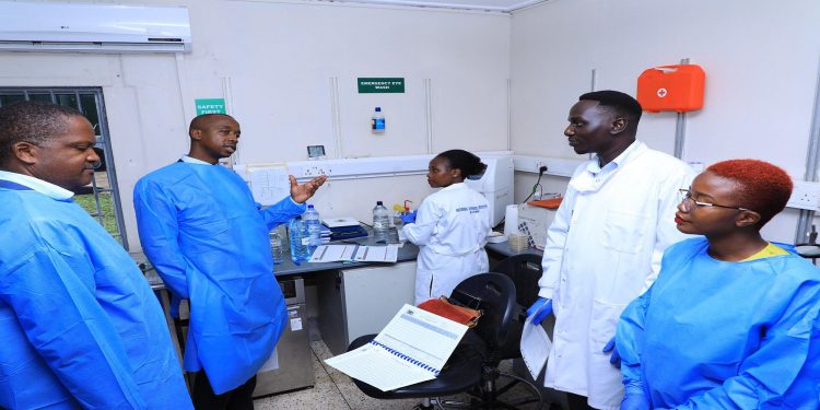 MPs led by Dr. Charles Ayume (2nd L) interacting with medical officers at Entebbe Hospital during the visit.