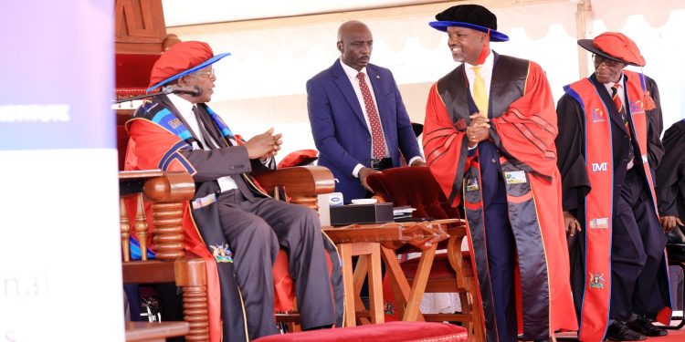 Thomas Tayebwa (Right) interacting with Justice Bart Katureebe.