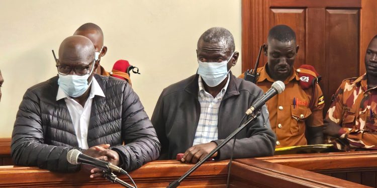 Besigye (Right) and Obedi Luatale in Court.