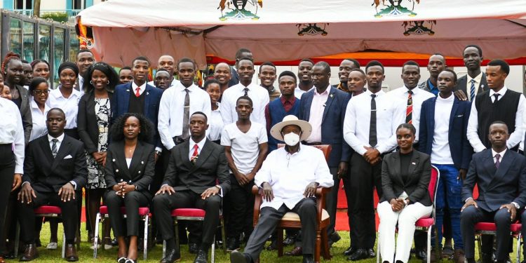 Churchill Ssentamu seated on the left of President Yoweri Museveni(in a mask).