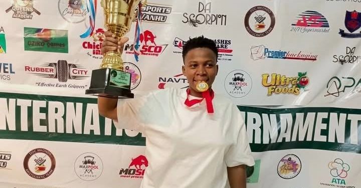 Rukia Naiga with her trophy and medal.