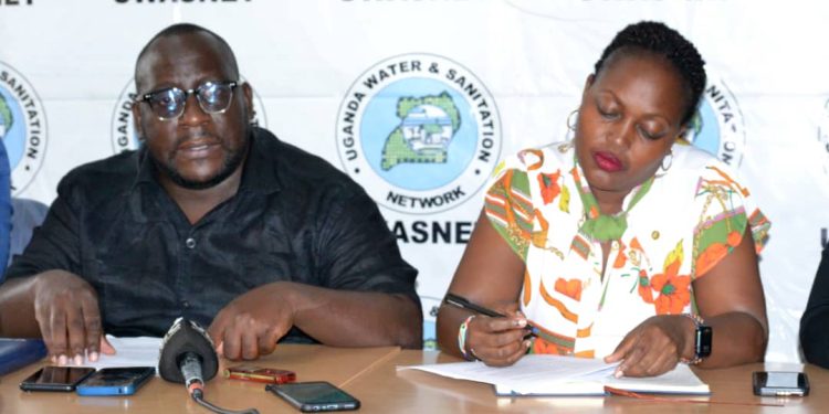 Martin Kityo, UWASNET’s Liaison and Networking Officer (L), and Marion Natukunda, Senior Communications Officer Thematic Lead WASH, at the Ministry of Health during the press conference at UWASNET offices in Luzira.