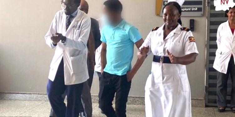 First kidney patient (in blue) being discharged from Mulago. Courtesy photo.