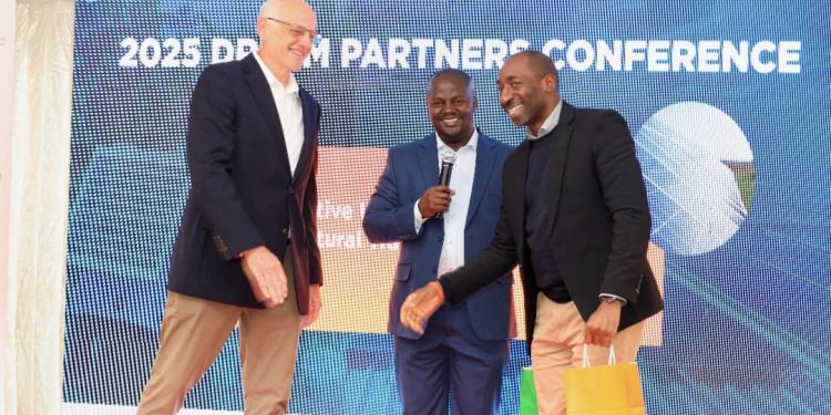 Samuel Booth Passmore, the head of programming at Mott Foundation, Dr. Robert Ddamulira Program Officer Mott Foundation and William Matovu share a light moment as the Mott Foundation celebrates and rewards all DREEMHUB partner leads across East Africa