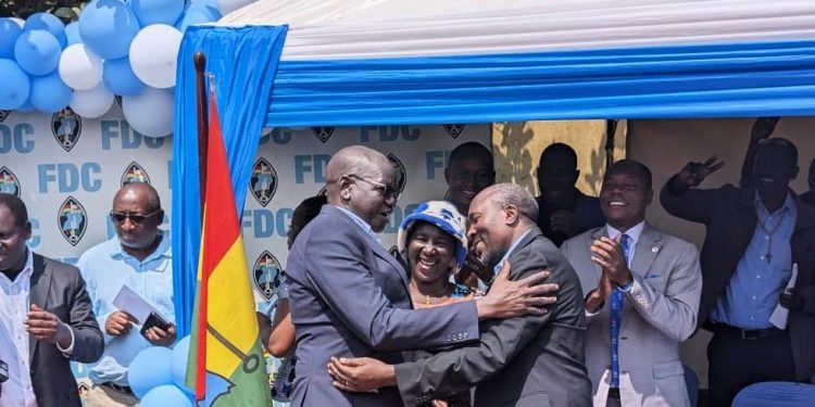 Amuriat (left) interacting with Mafabi after the announcement. Ugnewsline photo.