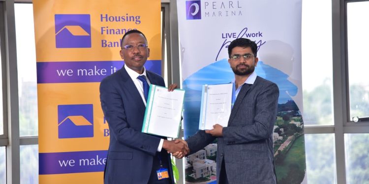 Micheal Mugabi, MD Housing Finance Bank (L) and Mr. Piyush Dixit the General Manager at Pearl Marina(R)