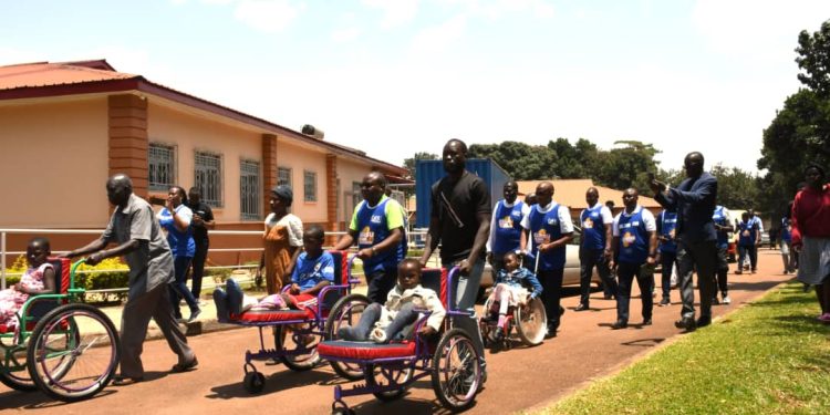 Some of the hospital staff and partners walking alongside some the children treated at the CoRSU Hospital.