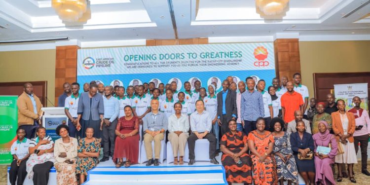 Beneficiaries from Makerere and Kyambogo University pose for a photo with officials from EACOP, CPP, the University Faculty and their parents during the scholarship launch in Kampala