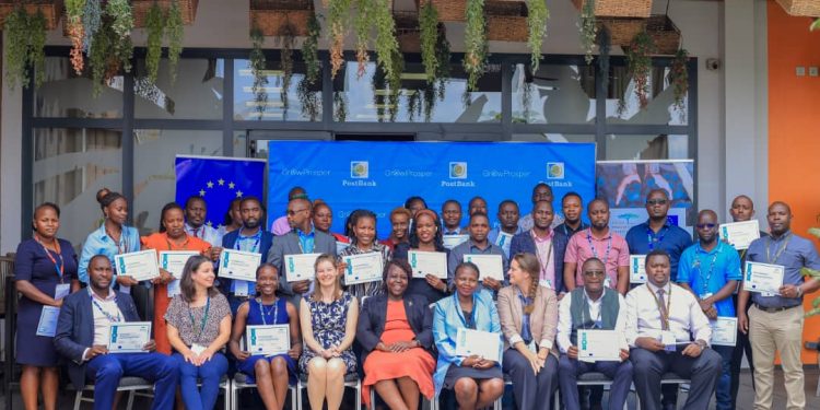 Head of Public Sector at PostBank Uganda, Andama Carolyn (C Front) , Christine Meyer (4th L Front), Project Lead of UGEFA and Head of Programme Green Entrepreneurship at adelphi, together with UGEFA officials and PostBank staff.