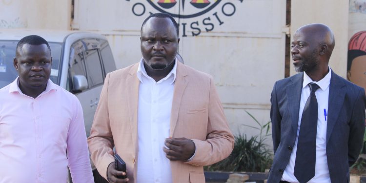 Dr Keddi Eric Stephen Zuluba (middle) and other officials at the EC.