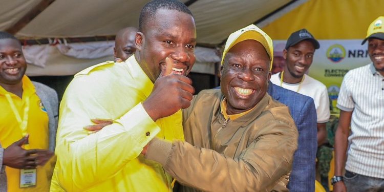 Collins Tanga (yellow shirt) and his father Dr. Tanga Odoi celebrating. Courtesy Photo.