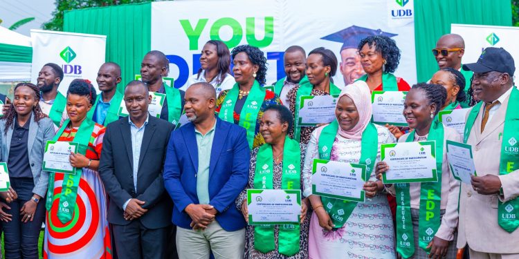 Graduates-from-the-Mbale-cohort-pose-for-a-group-photo-with-UDB-officials-and-MUBS-trainers