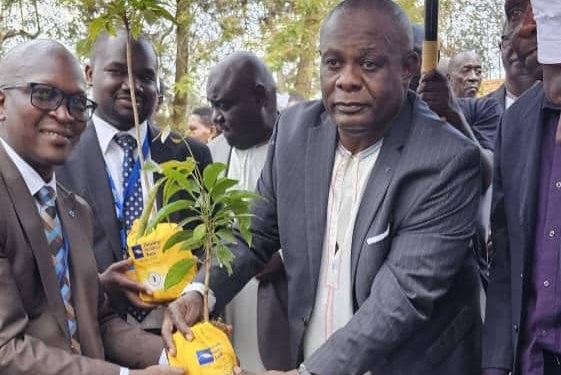 A-team-from-Housing-Finance-Bank-plants-a-tree-with-His-Highness-the-King-of-Kooki-Kingdom-Apollo-Ssansa-Kabumbuli-II