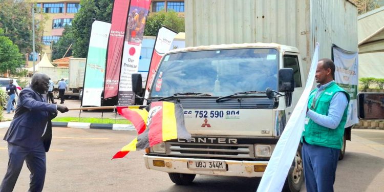 Alfred Dirwale, Commissioner of Health Services for Institutional Capacity Building and Human Resource Development and  Gebremichael Molla from Africa CDC flagging off the dissemination of Immunisation job aids at the ministry headquarters in Kampala.