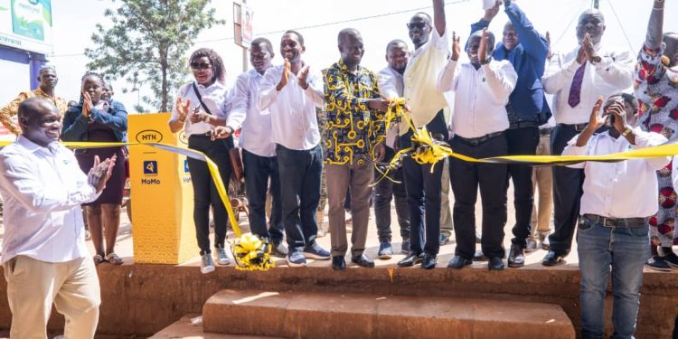 The MoMo team, alongside RCC Egole Lawrence & Mayor Sam Atul, officially opens the refreshed Lira Main Market