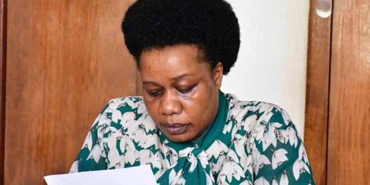 Dr. Sarah Bereete going through her charge sheet at Buganda Road Court.