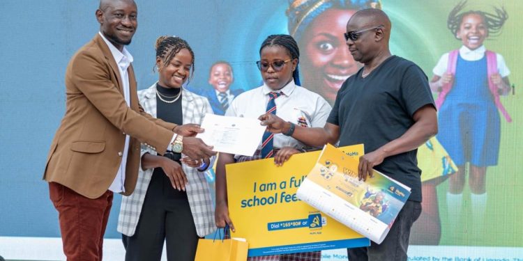 The first winner of the 2026 Win School Fees with MoMo campaign, Tony Magomu, receiving school fees for a full year for his daughter from MTN MoMo's CCO, Keith Tukei and CPO, Jemima Karuiki at the launch