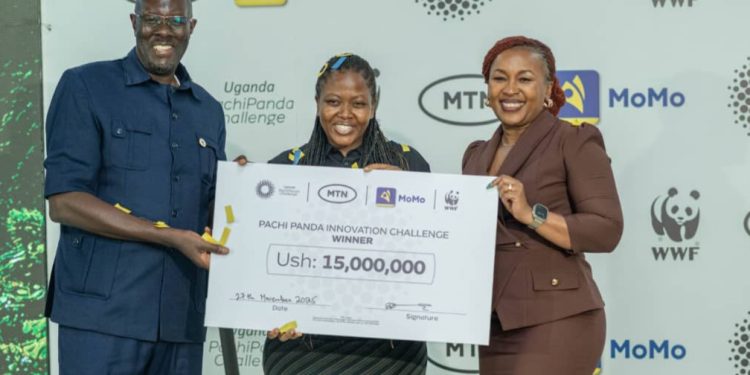 WWF Uganda Country Director Ivan Tumuhimbise (L) and MTN Uganda Chief Executive Officer Sylvia Mulinge present the top prize to Ruth Kyobutungi, founder of FarmGate Digital—an online platform that connects farmers to traders.