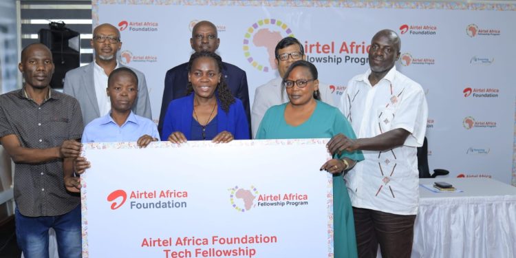 Airtel MD, Soumendra Sahu, (3rd R), Hannington Karuhanga, Board Chair Airtel (in black coat), Patrick Mbonye (in a grey coat), pose with some of the parents of the fellows in Kampala.