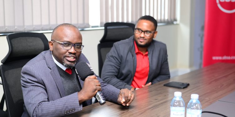 Absa MD, David Wandera flanked by Enock Kibuuka at the Prudential Offices