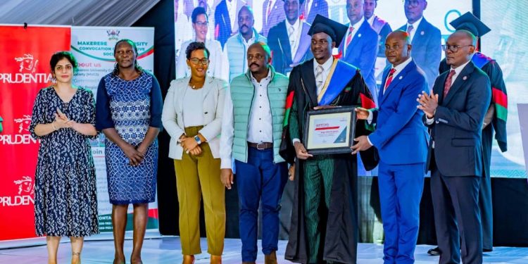 Edwaard Bbaale, Principal, College of Business and Management Sciences, Makerere University, hands over a certificate to one of the students selected as Peter Mugarura, Head of Marketing at Prudential Uganda, and other staff members look on.