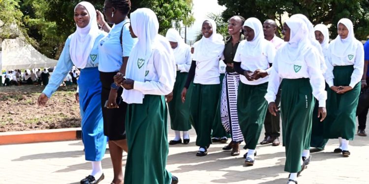 Stanbic's Head of CSI, Diana Ondoga joins the students to inspect the newly paved walkways.
