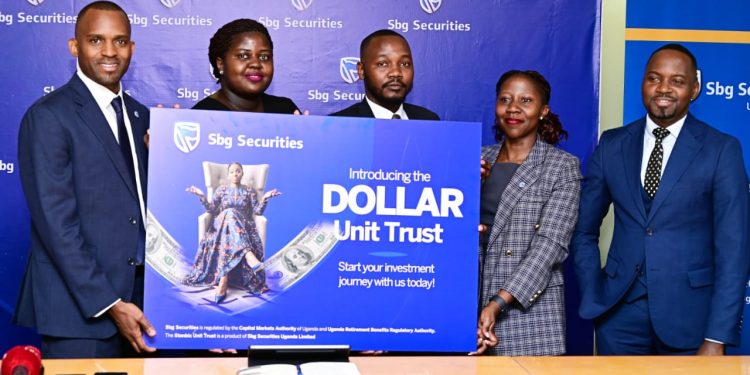 The SBG Securities team led by the Chief Executive Grace Semakula(left). Right is Stanbic Bank's Country Manager for Communication and Reputation, Kenneth Agutamba..