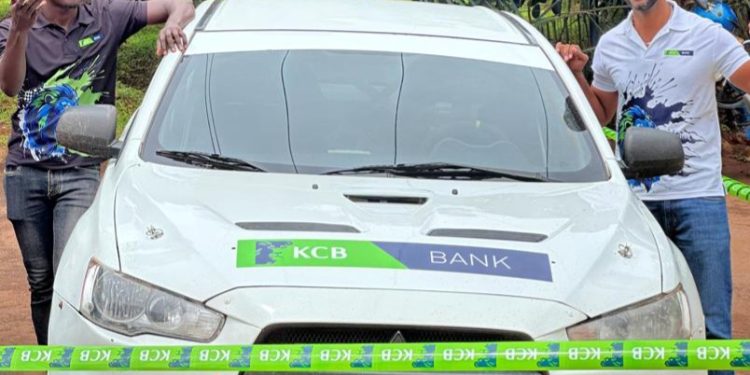 Oscar Ntambi (R) and co-driver Asumani Muhammadi (L) pose for a photo at the KCB flag off