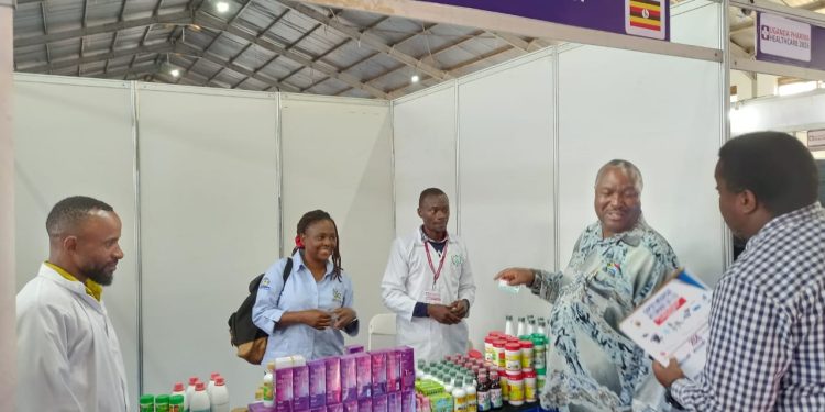 Dr.Ellioda being shown the herbal products by officials of Uganda herbalist Association