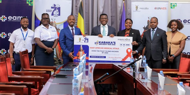 The Managing Director of East African Medical Vitals, Mr Brian Kavuya hands over the sponsorship cheque to the Katikkiro of Buganda Owekitiibwa Charles Peter Mayiga at Bulange Mmengo on 31st March 2026