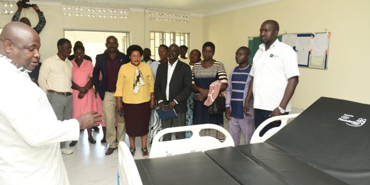 Andrew Mubangizi, in-charge of Maziba Sub-District Hospital (in a white overall), guides MTN Uganda staff led by Andrew Tusubira, alongside Kabale District leaders, during a tour of the facility on April 8, as the company