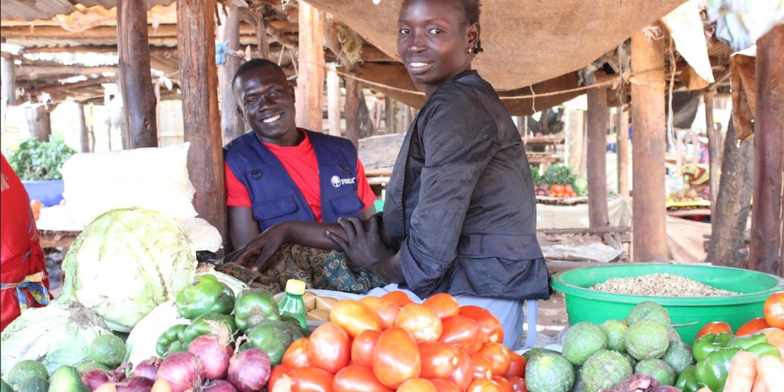 A youth in the Northern Region seated next to her small scale business