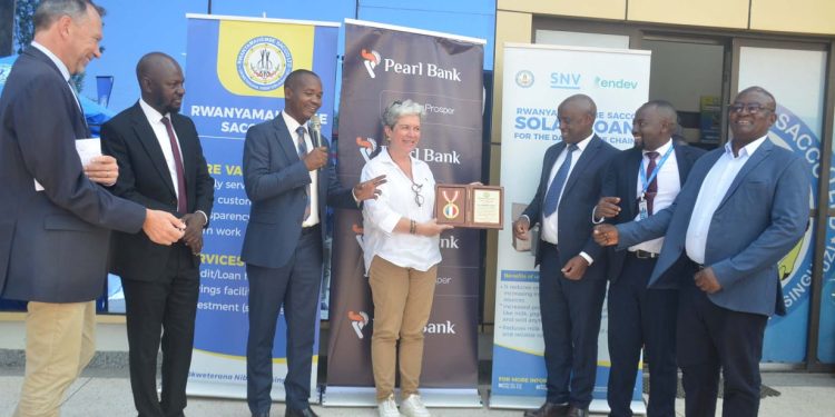 H.E. Virgine Leroy (C), Ambassador of France to the Republic of Uganda, receiving a souvenir. Looking on is Head Financial Institutions and Social Enterprises at Pearl Bank, George Williams Walusansa, (2nd L) Marc Trouyet (L), the Country Director for AFD in Uganda, joined by other officials from Rwanyamahembe SACCO during a courtesy visit to some of the beneficiaries of the Rwanyamahembe SACCO in Mbarara on 29th June 2026.