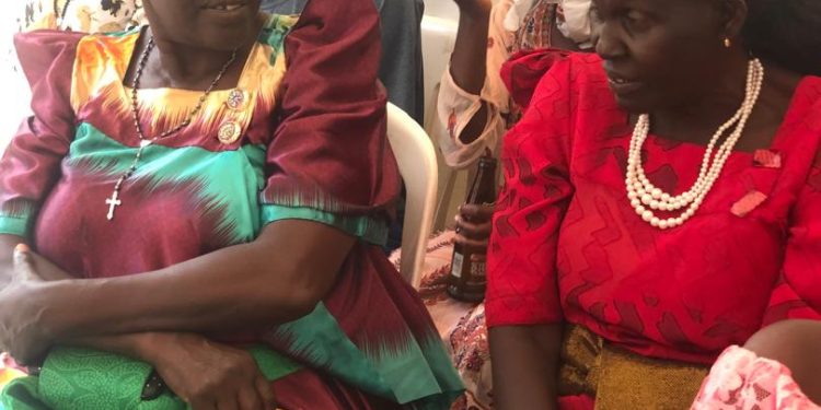 Bulasa Nalongo Victoria (extreme left in a maroon busuti) chats with a colleague during a recent function.