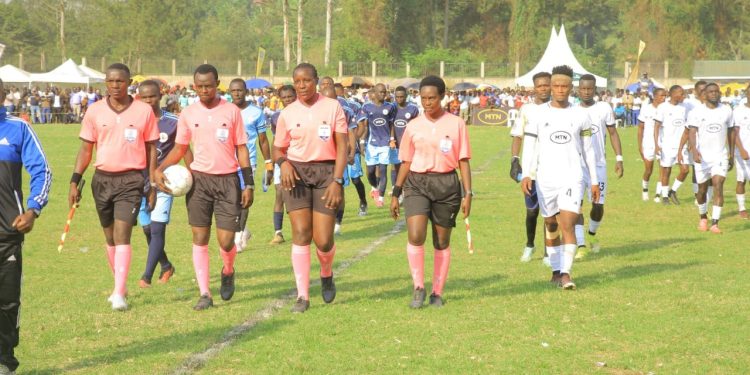 Fort Portal City and Mwenge North walk onto the pitch alongside match officials ahead of their Tooro Kingdom MTN Masaza Tournament clash at Buhinga Stadium, as fans gathered for another exciting day of football and community.