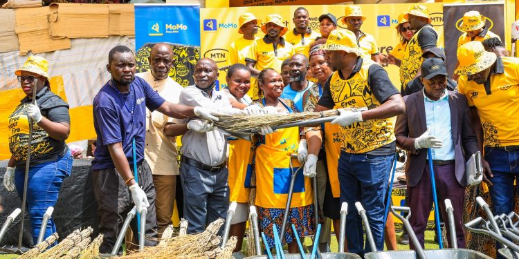 Traders at Soroti Main Market receive cleaning equipment from MTN Uganda as part of the Y'ello Storm community clean up initiative.